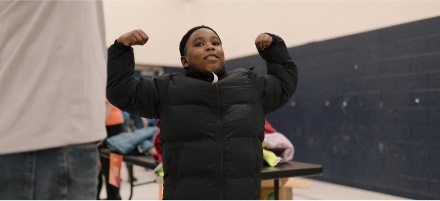 Child standing strong and confident with his new winter coat. 